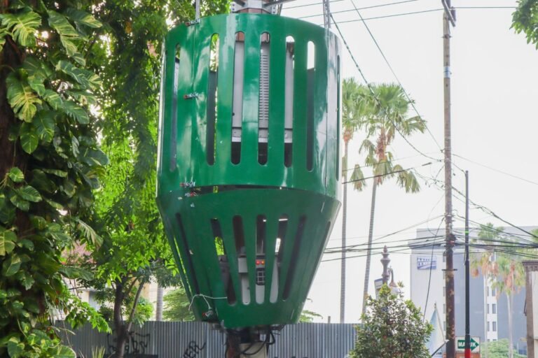 Pole-mounted electrical transformer with protective safety cage